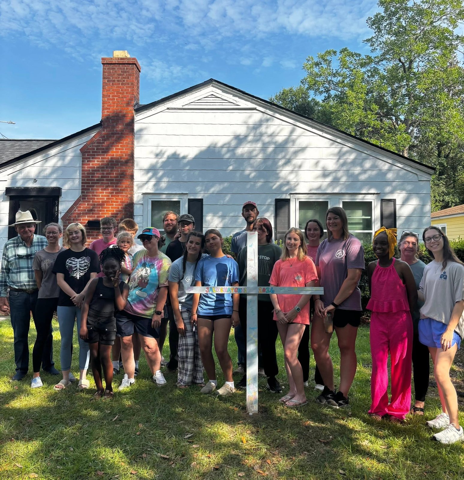 Salkehatchie team gathered around a signed Salkehatchie 2026 cross