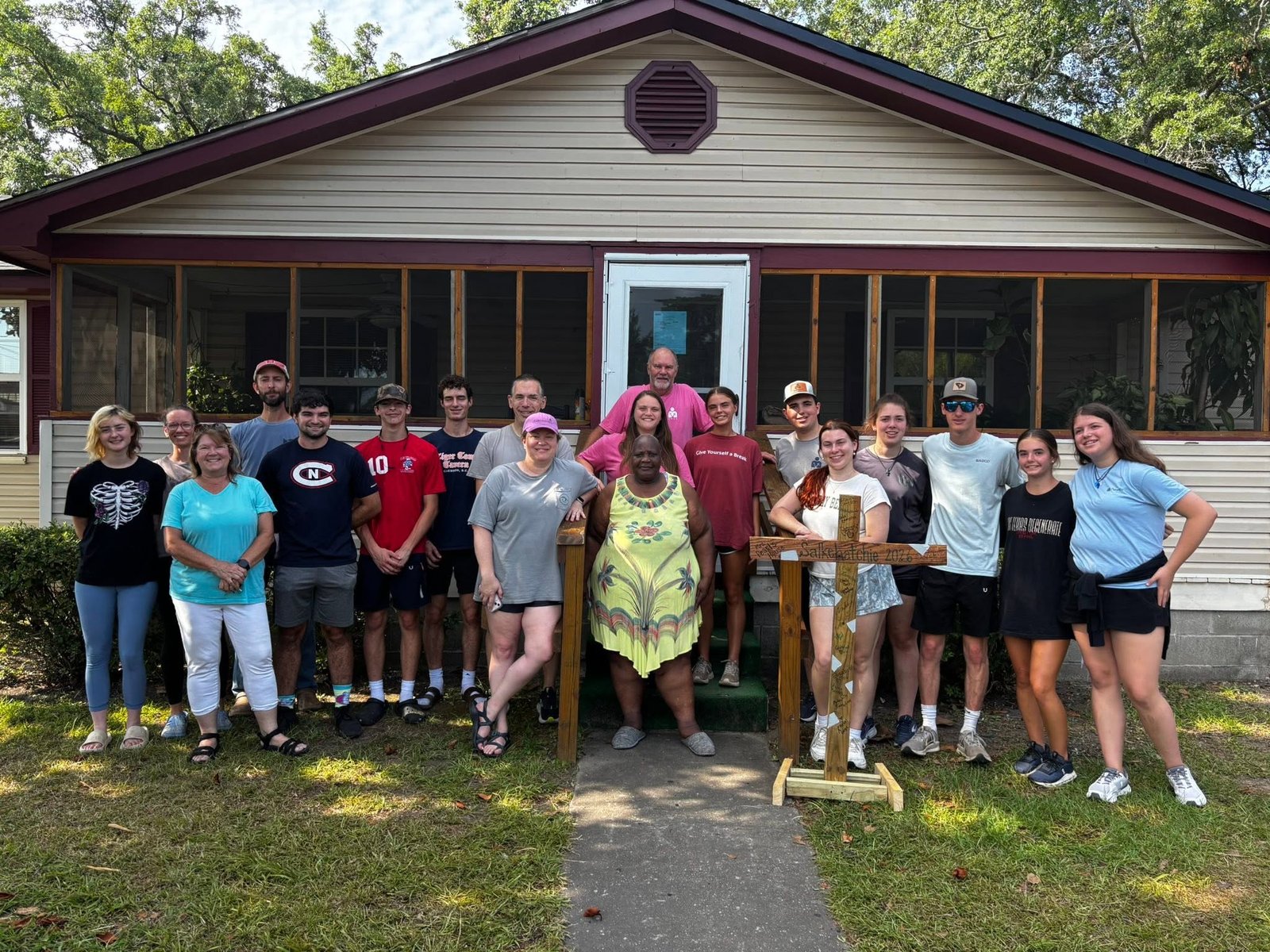 Salkehatchie volunteers with a neighbor in front of a home